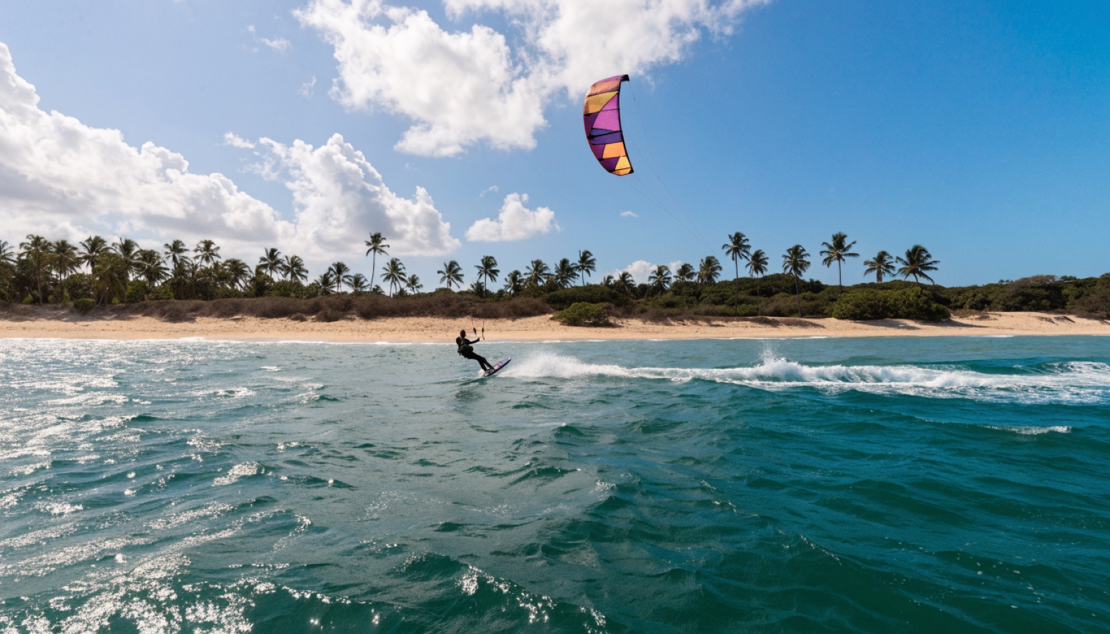Kiteboarder on turquoise water